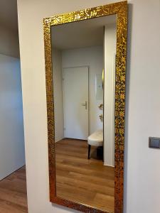a mirror on a wall in a room at Wallersee Retreat in Neumarkt am Wallersee +17 photos
