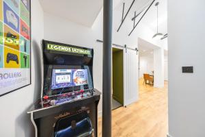 a video game machine in a room with a hallway at Elevated Escape - Hot tub, Sauna, Rooftop Terrace, Private Cinema Room in Seabrook