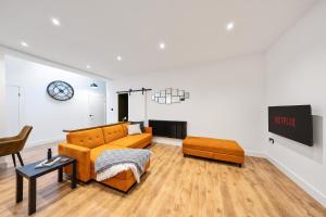 a living room with a couch and a table at Elevated Escape - Hot tub, sauna, rooftop terrace in Seabrook