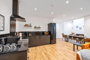 a kitchen and dining room with a table and chairs at Elevated Escape - Hot tub, Sauna, Rooftop Terrace, Private Cinema Room in Seabrook
