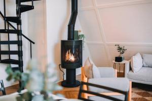 a living room with a wood stove in a room at Secluded A-Frame Hocking Hills Hot Tub Fire Pit in South Bloomingville