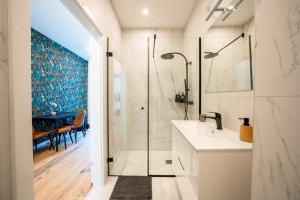 a bathroom with a shower and a sink at Velvet Vienna - at metro station U1 - 5 mins to opera in Vienna +270 photos