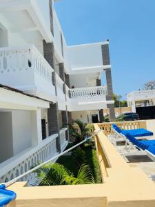 a view of the balcony of a house with blue lounge chairs at KK Homes in Diani Beach