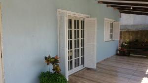 a room with white doors on the side of a house at summer house 2026 in Tramandaí