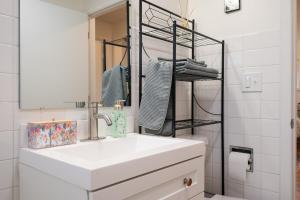 a bathroom with a white sink and a mirror at Spacious Retreat 3 Miles to Airport 12 to Seattle in Burien +50 photos