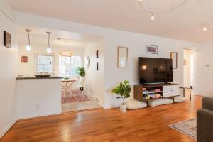 a living room with a television and a table at Spacious Retreat 3 Miles to Airport 12 to Seattle in Burien