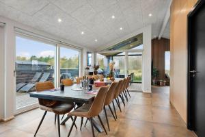 a dining room with a long table and chairs at TV1697-Jerup-Engsig-Baekvej-42 in Bratten Strand