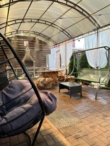 a living room with a chair and a table at Банний Двір in Kryvyi Rih