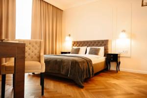 a bedroom with a bed and a chair at Lumina OVO in Wrocław +27 photos