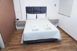 a bedroom with a large bed with white sheets at Wyka Hotel in Trujillo +55 photos