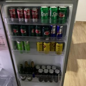 a refrigerator filled with lots of drinks and sodas at Casa de campo in Extrema