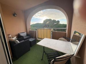 a room with a table and chairs and a window at Studio ensoleillé près du port et des plages in Hyères +17 photos