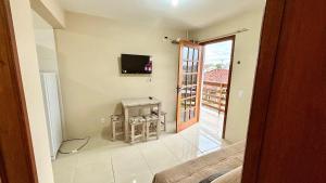 a view of a living room with a tv on the wall at Residencial Villa Del Mare in Tramandaí
