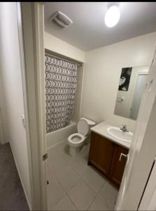 a bathroom with a toilet and a sink at Budget Friendly Home in Oshawa