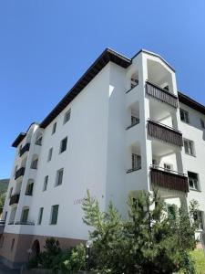 a white building with balconies on the side of it at Ferienwohnung Gian in Davos