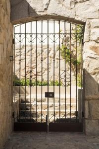 a door with a metal gate in a stone wall at Casapueblo Rent Cachagua CP 02 in Cachagua