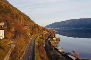 an aerial view of a road next to a lake at DeliApart Ossiacher See in Sattendorf +46 photos