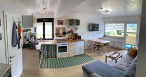 a kitchen and a living room with a couch at DeliApart Ossiacher See in Sattendorf