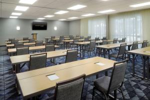 an empty room with tables and chairs and a podium at Courtyard by Marriott Perimeter Center in Atlanta +24 photos