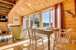 a dining room with a table and chairs at Direct Lake Access! Quiet Waukewan Retreat in Winona