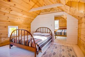 a bedroom with two beds in a log cabin at Direct Lake Access! Quiet Waukewan Retreat in Winona
