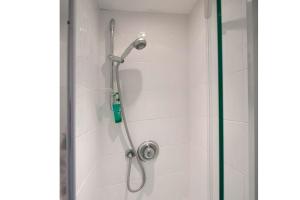 een douche met een douchekop in een badkamer bij Abacus Bed and Breakfast, Blackwater, Hampshire in Camberley +40 foto's