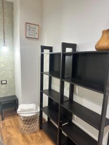 a black book shelf in a living room at Spàzio apartments Alcalà in Catania
