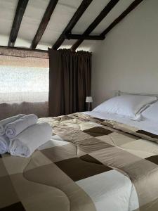 a bedroom with a large bed with towels on it at Alloggio Turistico LA TORRE in Acquapendente