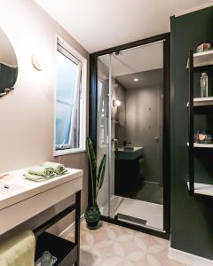 a bathroom with a shower and a sink and a mirror at Camping Papillon Kinrooi - 78 in Kinrooi