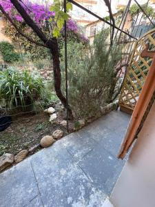 a garden with purple flowers and a wooden gate at Chez Marlène bis, Vieil Antibes, Port Vauban in Antibes
