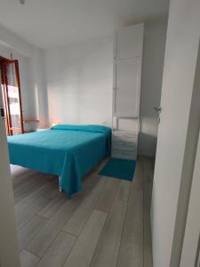 a bedroom with a bed with a blue bedspread at Seaview Allegra in Montesilvano