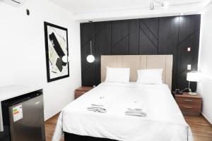 a bedroom with a large bed with a black wall at Wyka Hotel in Trujillo
