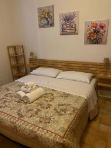 a bed in a bedroom with two towels on it at Alloggio Turistico LA TORRE in Acquapendente +6 photos