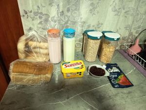 a counter topped with containers of food and other ingredients at Mate Sur Hostal in Cochrane +15 photos