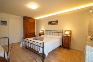 a bedroom with a bed and two night stands at Torretta dependance in Assisi