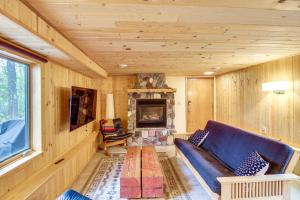 a living room with a couch and a fireplace at Mille Lacs Lake Retreat! Cabin with Private Dock in Bayview