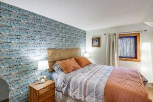 a bedroom with a bed and a blue wall at Mille Lacs Lake Retreat! Cabin with Private Dock in Bayview