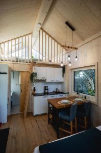 a kitchen and dining room with a wooden table at Nature Living Koralpe in Sankt Stefan im Lavanttal