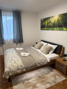 a bedroom with a bed with two towels on it at Wallersee Retreat in Neumarkt am Wallersee