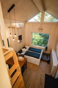 a small room with a bed and a couch at Nature Living Koralpe in Sankt Stefan im Lavanttal