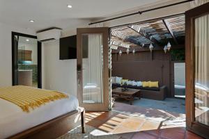 a bedroom with a bed and a living room at Talavera Palm Springs in Palm Springs +200 photos