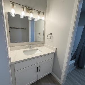 a bathroom with a sink and a mirror at Empire Extended Stay in Webster