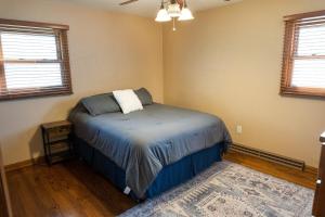 a bedroom with a bed in the corner of a room at Convenient Countryside Oasis in Caledonia