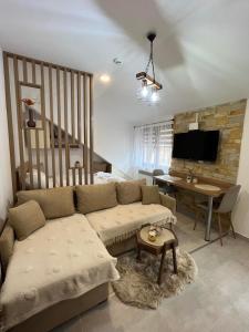 a living room with a couch and a table at Amprtman PETKOVIĆ NLux 110 Milmari resort in Kopaonik