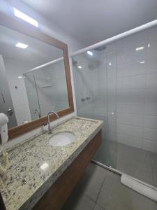 a bathroom with a sink and a glass shower at Hotel Imperial Flat in João Pessoa +13 photos