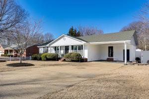 a white house with a driveway at Modern Pet-Friendly Home with Covered Patio and Yard in Jackson