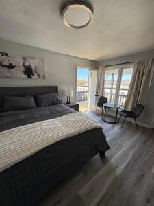 a bedroom with a large bed and a large window at Empire Extended Stay in Webster