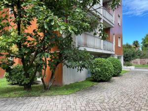 ein Gebäude mit einem Baum neben einer steinernen Einfahrt in der Unterkunft Novate Fiera in Novate Milanese