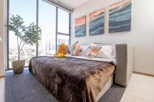 a large bed in a room with large windows at Modern Stay in the Heart of Guadalajara in Guadalajara +58 photos