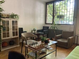 a living room with a chess board on a table at Chillton hostel in Belgrade